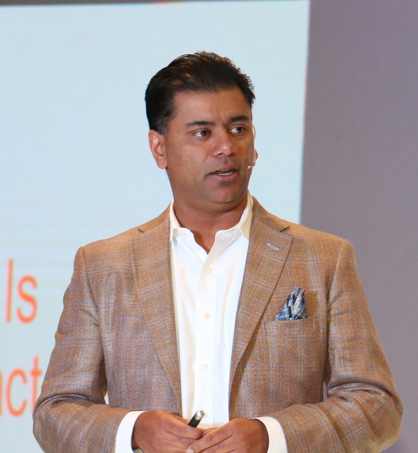 Ashish Bisaria speaking on stage